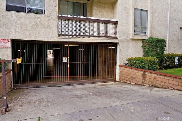 exterior space with concrete driveway, fence, and a garage