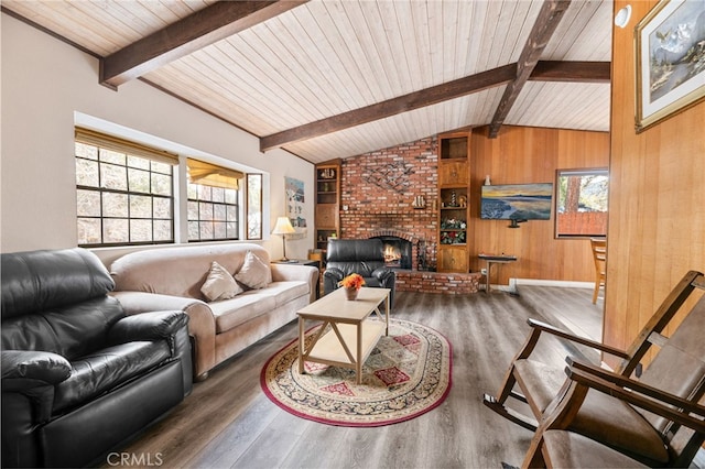 living area with wood finished floors, wood walls, a brick fireplace, wood ceiling, and vaulted ceiling with beams