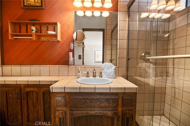 bathroom featuring a shower stall and vanity