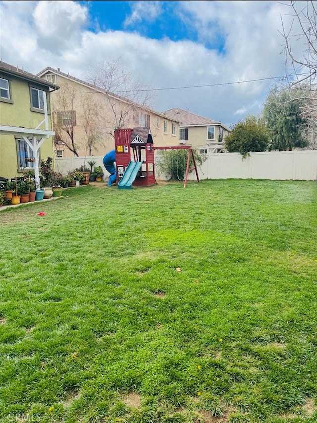 view of yard with a playground and fence