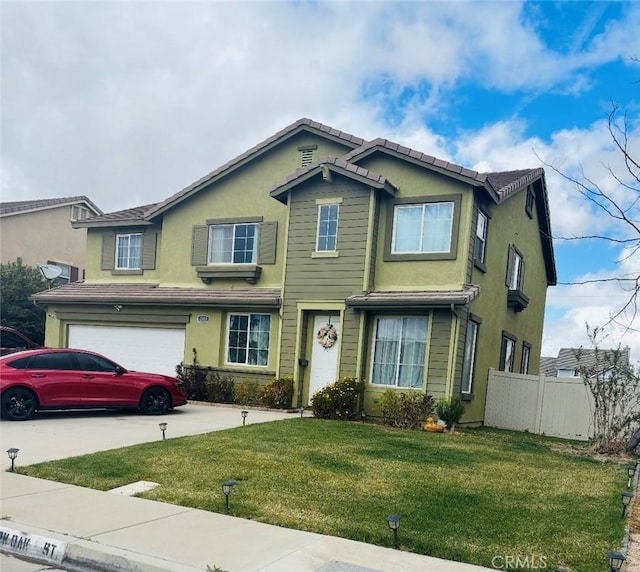 traditional-style home with an attached garage, fence, driveway, and stucco siding