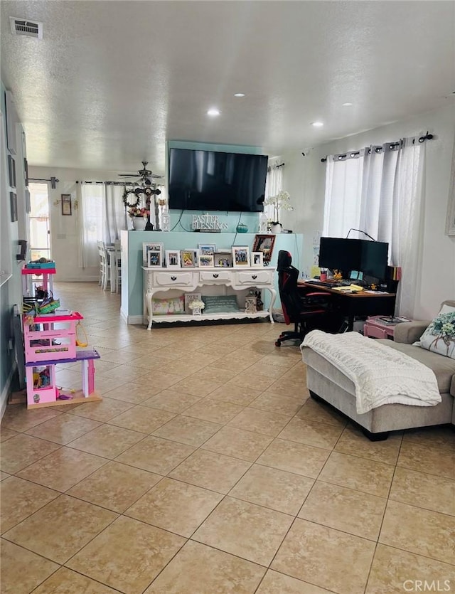 living area with recessed lighting, visible vents, a textured ceiling, and light tile patterned flooring