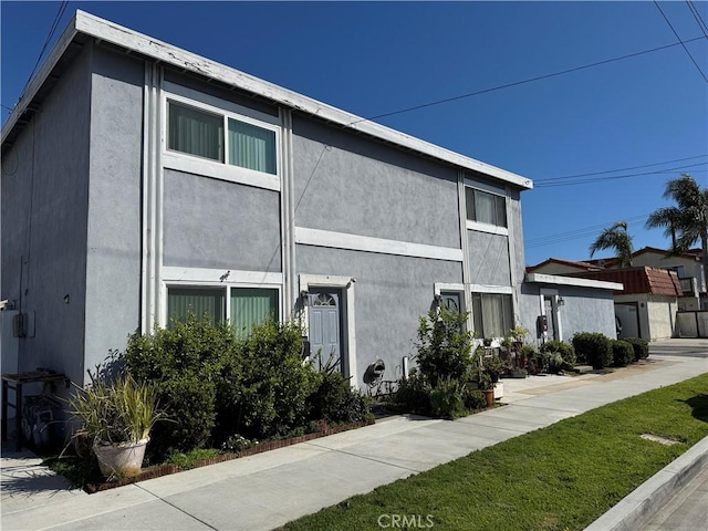 view of side of property featuring stucco siding