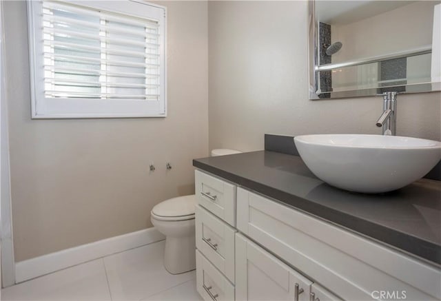 full bathroom featuring tile patterned flooring, walk in shower, baseboards, toilet, and vanity