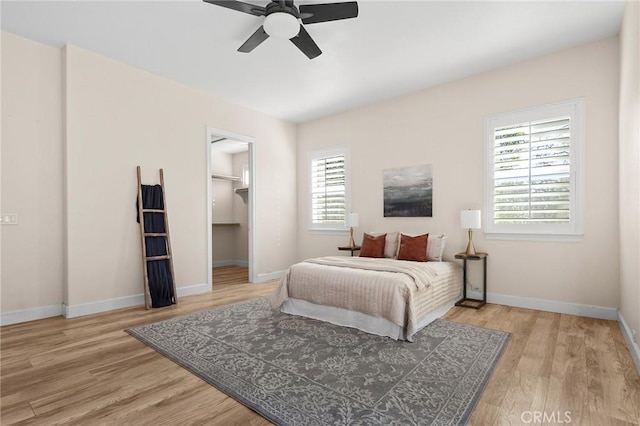 13725 Nimshew Rd, Magalia, CA 95954 - bedroom with a walk in closet, a ceiling fan, baseboards, and light wood finished floors