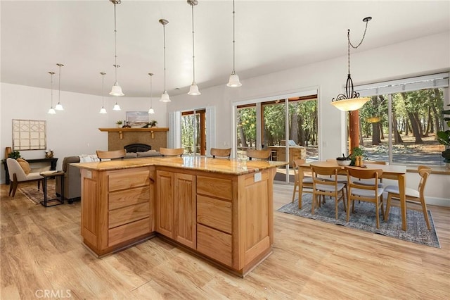 13725 Nimshew Rd, Magalia, CA 95954 - kitchen featuring a fireplace, light wood finished floors, and pendant lighting