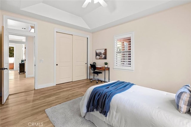 13725 Nimshew Rd, Magalia, CA 95954 - bedroom featuring a ceiling fan, a closet, baseboards, light wood-style floors, and a raised ceiling