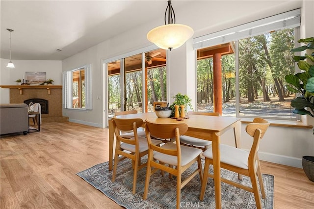 13725 Nimshew Rd, Magalia, CA 95954 - dining space with a healthy amount of sunlight, light wood finished floors, and a fireplace with raised hearth