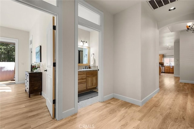 13725 Nimshew Rd, Magalia, CA 95954 - hall featuring baseboards, arched walkways, and light wood finished floors