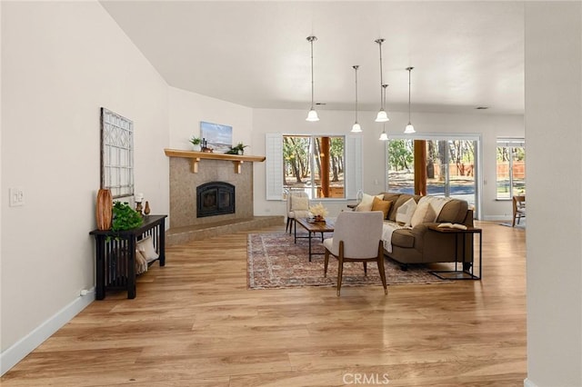 13725 Nimshew Rd, Magalia, CA 95954 - living room with light wood-type flooring, baseboards, and a tile fireplace