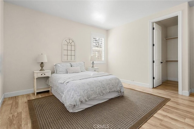 13725 Nimshew Rd, Magalia, CA 95954 - bedroom featuring light wood finished floors, a spacious closet, and baseboards