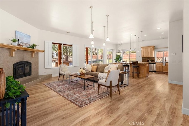13725 Nimshew Rd, Magalia, CA 95954 - living room featuring light wood-type flooring, baseboards, and a tile fireplace