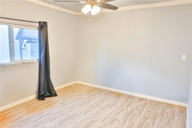 unfurnished room with baseboards, ceiling fan, and wood finished floors