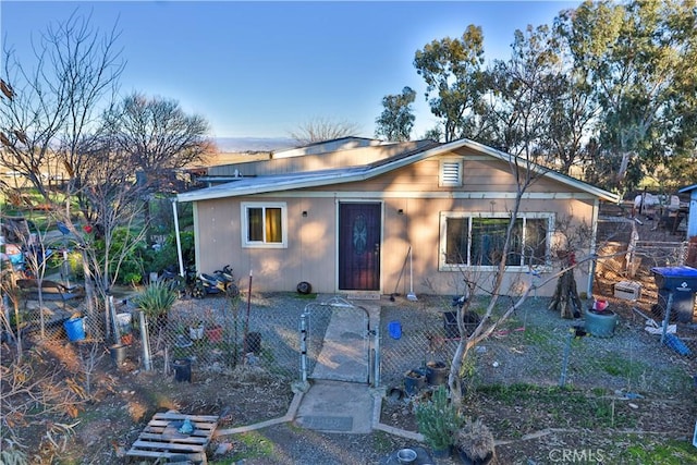 bungalow-style home featuring fence