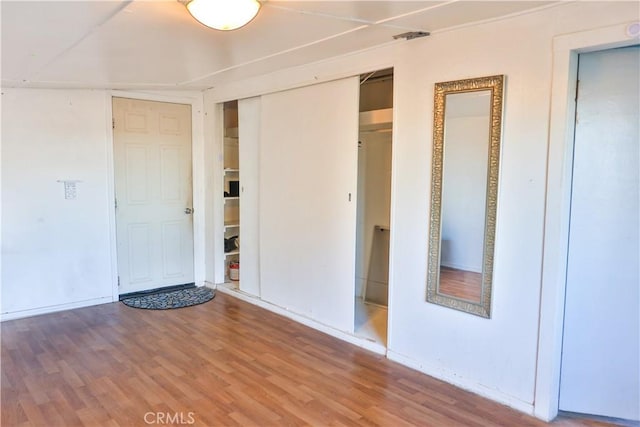 interior space with wood finished floors and a closet