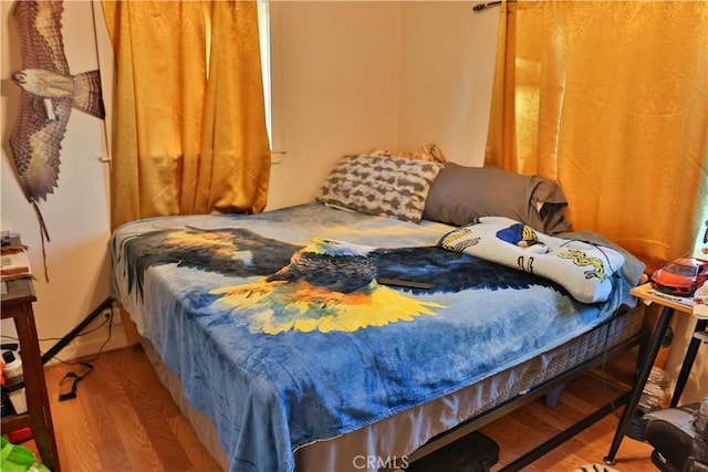 bedroom featuring wood finished floors