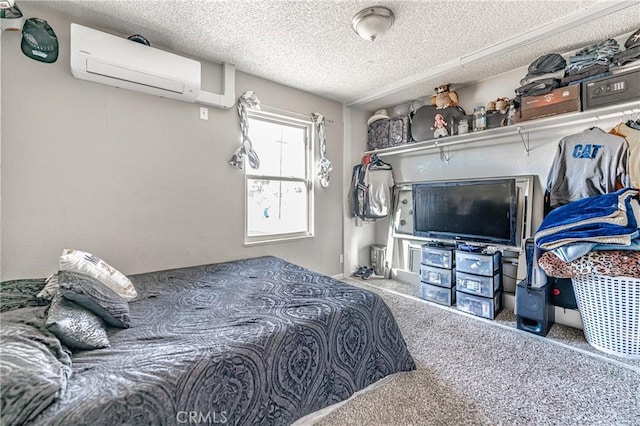 bedroom with a textured ceiling, an AC wall unit, and carpet floors