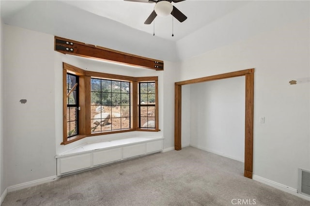 carpeted spare room with baseboards and ceiling fan