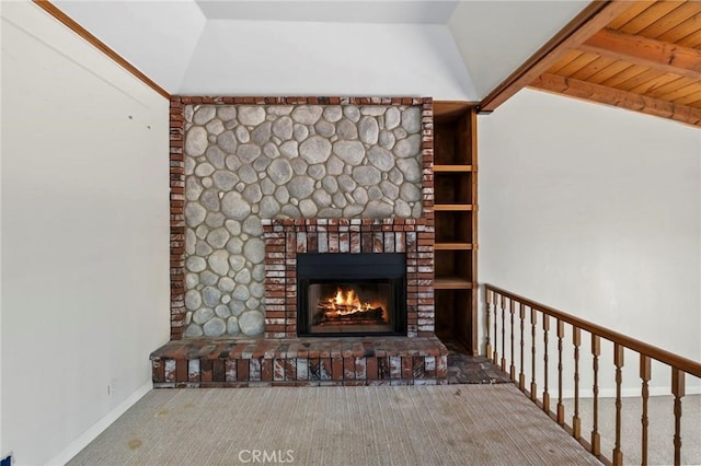 interior details featuring beam ceiling, a brick fireplace, baseboards, and carpet