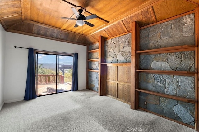 carpeted empty room with wooden ceiling, a ceiling fan, and built in shelves