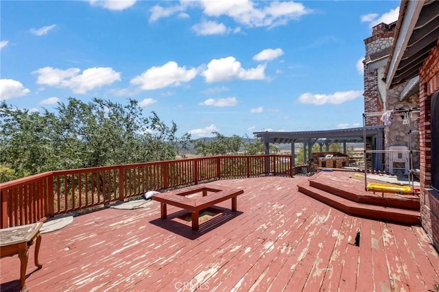 wooden deck featuring a pergola