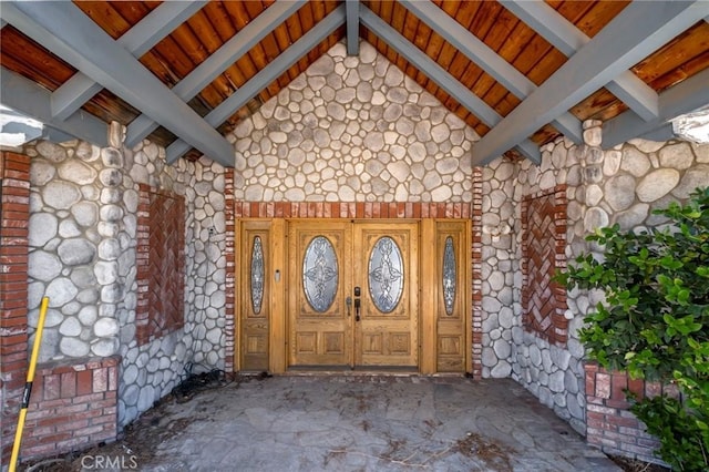 property entrance with stone siding