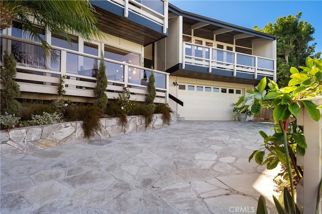 exterior space with a garage and concrete driveway