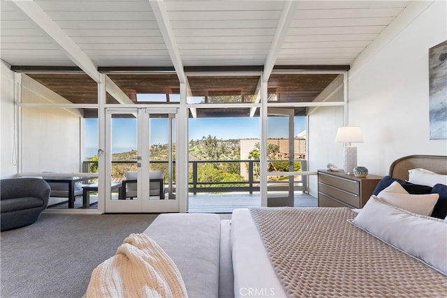 bedroom with expansive windows, beamed ceiling, access to exterior, and carpet flooring