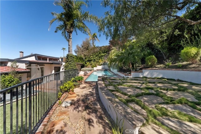 exterior space featuring a patio, fence, and a fenced in pool