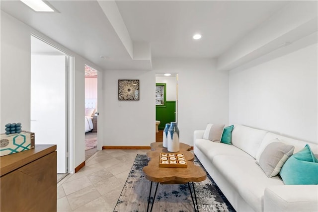 living room featuring light tile patterned floors, recessed lighting, and baseboards