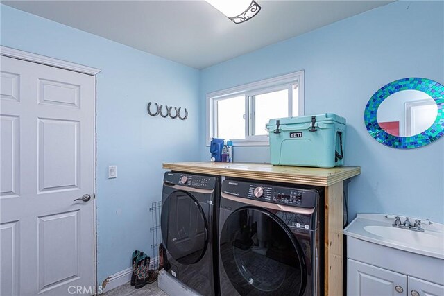 laundry room with a sink and washing machine and clothes dryer