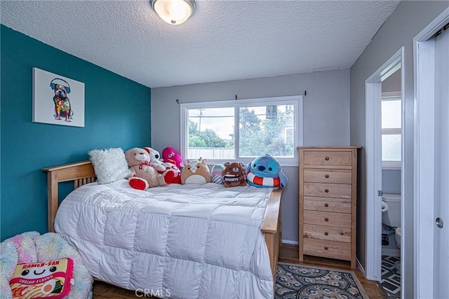 bedroom featuring a textured ceiling and wood finished floors