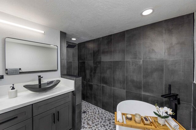 32404 Womsi Rd, Pauma Valley, CA 92061 - full bath with walk in shower, vanity, a freestanding tub, a textured ceiling, and recessed lighting