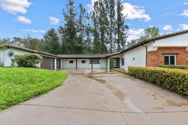 32404 Womsi Rd, Pauma Valley, CA 92061 - view of front of property featuring stucco siding, driveway, a tile roof, and a front yard