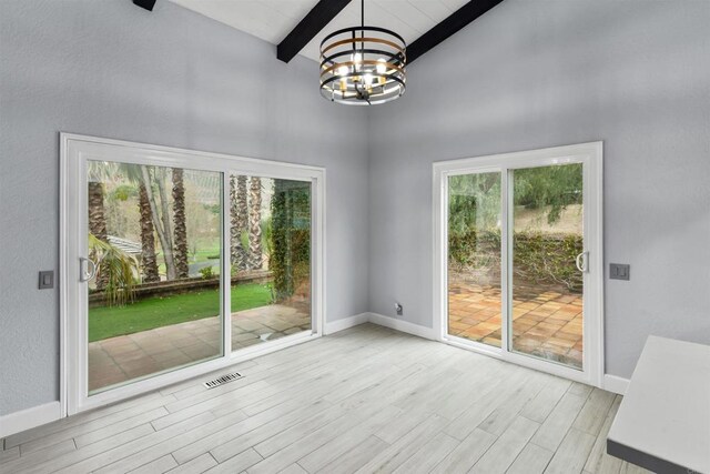 32404 Womsi Rd, Pauma Valley, CA 92061 - unfurnished dining area featuring a chandelier, beam ceiling, a high ceiling, and wood finished floors