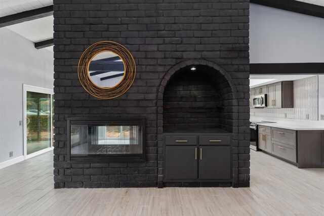 32404 Womsi Rd, Pauma Valley, CA 92061 - detailed view of appliances with stainless steel finishes, a brick fireplace, and wood finished floors