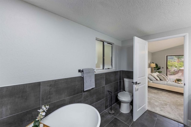 32404 Womsi Rd, Pauma Valley, CA 92061 - bathroom with tile patterned floors, tile walls, and a textured ceiling