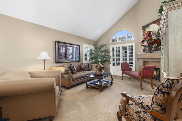 living area featuring light carpet, a tile fireplace, and high vaulted ceiling