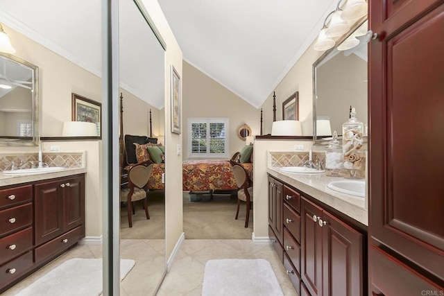 ensuite bathroom featuring ensuite bath, vaulted ceiling, double vanity, and a sink