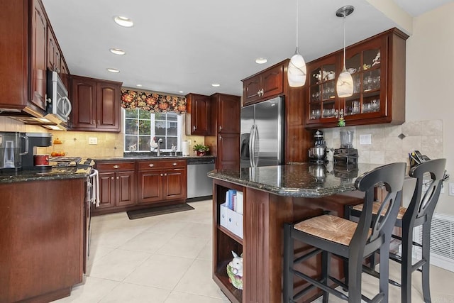 kitchen with open shelves, glass insert cabinets, appliances with stainless steel finishes, a peninsula, and a sink