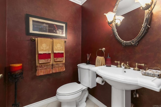 half bathroom featuring baseboards and toilet