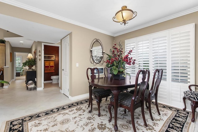 dining area with light tile patterned floors, baseboards, and ornamental molding