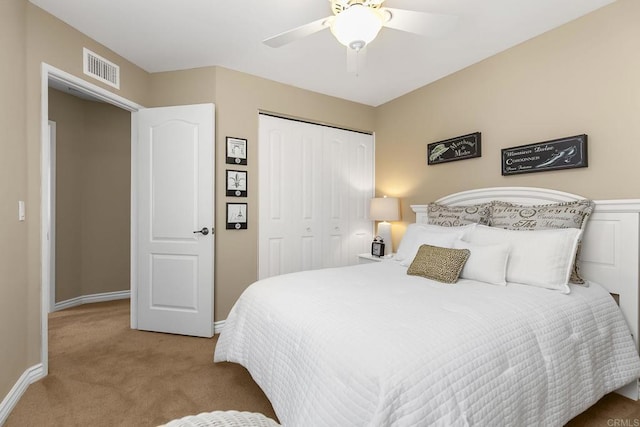 bedroom with visible vents, ceiling fan, baseboards, carpet, and a closet