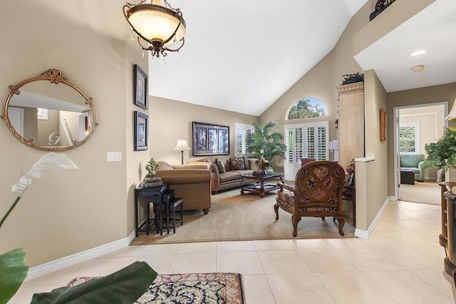 living room featuring light tile patterned floors, light carpet, high vaulted ceiling, and baseboards