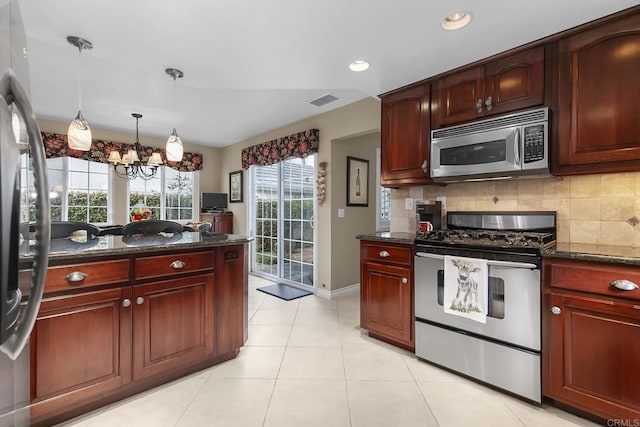 kitchen featuring visible vents, pendant lighting, backsplash, appliances with stainless steel finishes, and dark brown cabinets