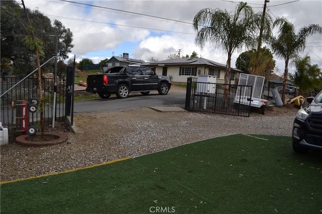 view of front of home featuring driveway and fence