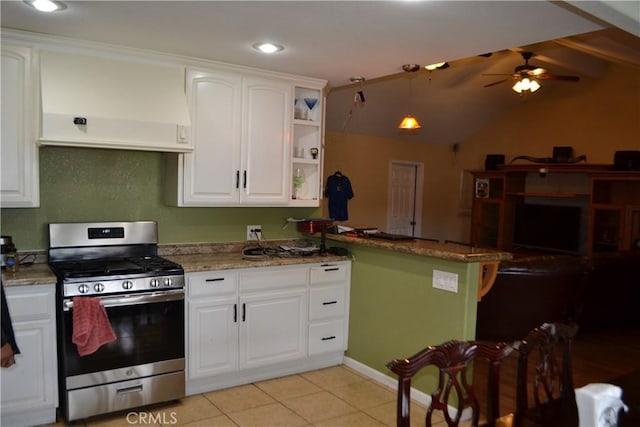 kitchen featuring a ceiling fan, premium range hood, a peninsula, white cabinets, and gas range