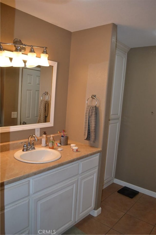 bathroom with vanity, tile patterned floors, and baseboards