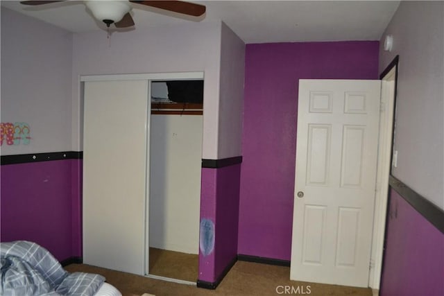 carpeted bedroom with a closet and ceiling fan