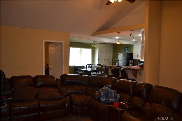 living room with ceiling fan and vaulted ceiling